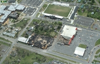 Aerial view of damage to the Foodland grocery store and adjacent buildings in downtown Albertville ~ 881 kb